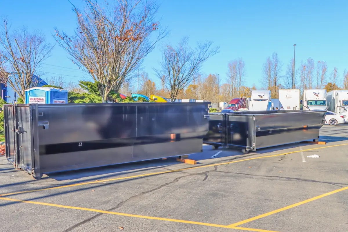 Professional dumpster rental service with roll-off container on residential driveway in Lake Bluff